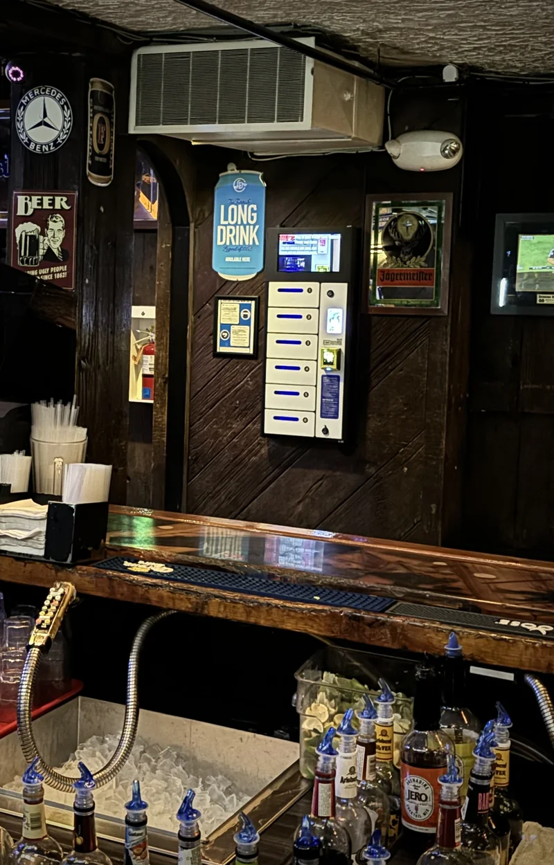 Charging locker mounted on the wall behind the bar at a campus pub