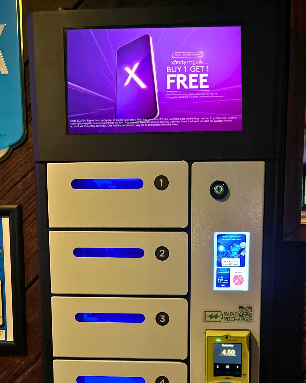 Charging locker at Scorekeepers playing an Xfinity Mobile ad on its screen